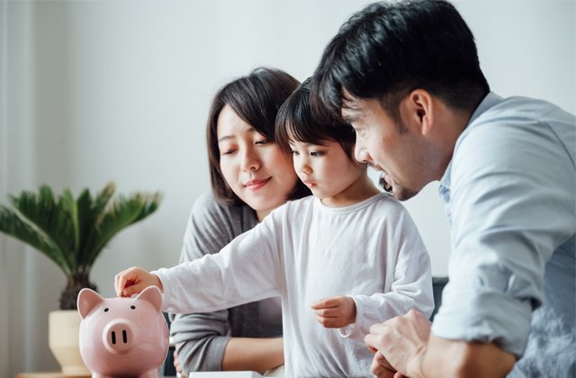 Parents reviewing their household budget together at the kitchen table
